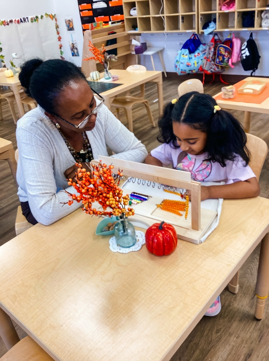 A Montessori teacher assisting a Children's House student with a golden bead mathematics lesson, fostering concentration and early math skills.